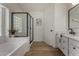 Bright bathroom showcasing a tub, separate glass-enclosed shower, and modern vanity at 42067 W Anne Ln, Maricopa, AZ 85138