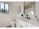 A charming bathroom boasts modern fixtures, elegant decor, and abundant natural light at 42067 W Anne Ln, Maricopa, AZ 85138