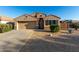 Charming single-story home featuring desert landscaping, a two-car garage, and a tiled roof at 42067 W Anne Ln, Maricopa, AZ 85138