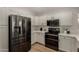 Updated kitchen featuring stainless steel appliances, white cabinetry, and ample counter space at 42067 W Anne Ln, Maricopa, AZ 85138