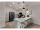 Modern kitchen featuring sleek countertops, stainless steel appliances, and barstool seating at 42067 W Anne Ln, Maricopa, AZ 85138