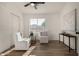 Sun-filled office with wood floors offers an inviting workspace, combining comfort and productivity at 42067 W Anne Ln, Maricopa, AZ 85138