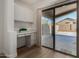 Bright office nook with a built-in desk and storage, located next to sliding glass doors at 42067 W Anne Ln, Maricopa, AZ 85138