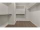 Walk-in closet with carpet, shelving, and hanging rods, maximizing storage space at 42067 W Anne Ln, Maricopa, AZ 85138