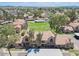 Aerial view of townhomes showcasing landscaped areas, desert trees, and community greenspace at 4601 N 102Nd Ave # 1116, Phoenix, AZ 85037