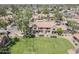Aerial view of community townhomes featuring greenspace, parking, and mature desert landscaping at 4601 N 102Nd Ave # 1116, Phoenix, AZ 85037