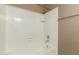 White tiled shower and tub combination featuring modern fixtures at 4601 N 102Nd Ave # 1116, Phoenix, AZ 85037