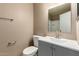 Bathroom featuring gray vanity, white toilet, and neutral walls at 4601 N 102Nd Ave # 1116, Phoenix, AZ 85037