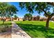 View of manicured community with grassy areas and mature trees at 4601 N 102Nd Ave # 1116, Phoenix, AZ 85037