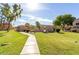 A well-manicured community space featuring sidewalks, lush green grass, and mature trees at 4601 N 102Nd Ave # 1116, Phoenix, AZ 85037