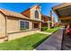 Charming condo featuring well-kept lawns, desert landscaping, assigned parking, and a unique barrel tile roof at 4601 N 102Nd Ave # 1116, Phoenix, AZ 85037