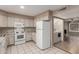 Bright kitchen with white cabinets, appliances, and granite countertops. Includes washer and dryer at 4601 N 102Nd Ave # 1116, Phoenix, AZ 85037