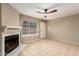 Inviting living room featuring neutral tile floors, a fireplace, and a bright window, a great space at 4601 N 102Nd Ave # 1116, Phoenix, AZ 85037