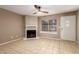 Inviting living room featuring neutral tile floors, a fireplace, and a bright window, a great space at 4601 N 102Nd Ave # 1116, Phoenix, AZ 85037