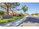 Street view of Discovery at Villa de Paz featuring community sign, sidewalks, and well-maintained landscaping at 4601 N 102Nd Ave # 1116, Phoenix, AZ 85037