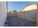 Home's backyard features gravel landscaping and block wall fencing at 4855 E Gary St, Mesa, AZ 85205
