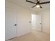 Bedroom featuring neutral walls, ceiling fan, and two doors for easy access at 4855 E Gary St, Mesa, AZ 85205