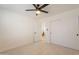 Minimalist bedroom featuring neutral walls, ceiling fan, and a view into an adjacent room at 4855 E Gary St, Mesa, AZ 85205