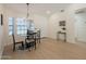 Bright dining area features a modern chandelier, neutral paint, and a dining table with four chairs at 4855 E Gary St, Mesa, AZ 85205