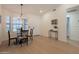 Bright dining area features a modern chandelier, neutral paint, and a dining table with four chairs at 4855 E Gary St, Mesa, AZ 85205