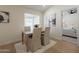 Bright dining room with wood table and chairs and view into main bedroom at 4855 E Gary St, Mesa, AZ 85205