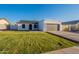 Charming home features a well-manicured lawn, neutral color palette, and a two-car garage at 4855 E Gary St, Mesa, AZ 85205