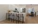 Island kitchen with stone counter tops, stainless appliances, and eat-in bar at 4855 E Gary St, Mesa, AZ 85205