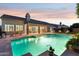 Beautiful backyard with a refreshing pool, outdoor seating, and elegant lighting at twilight at 4960 E Dale Ln, Cave Creek, AZ 85331