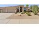 Desert home showcasing a two-car garage, manicured landscaping, and desert xeriscaping at 4960 E Dale Ln, Cave Creek, AZ 85331