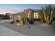 Desert home with a tile roof, three-car garage, desert landscaping, and walkway at 4960 E Dale Ln, Cave Creek, AZ 85331