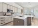 A bright kitchen features white cabinets, a center island, and stainless steel appliances at 4960 E Dale Ln, Cave Creek, AZ 85331