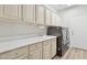 Bright laundry room with updated appliances, ample counter space, and cabinets for storage at 4960 E Dale Ln, Cave Creek, AZ 85331