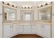 A spacious bathroom has double sinks with a vanity and mirrors along with a glass shower at 4960 E Dale Ln, Cave Creek, AZ 85331