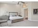 A large primary bedroom has an ensuite bathroom entrance, soft colors, and plush carpet at 4960 E Dale Ln, Cave Creek, AZ 85331