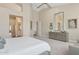 A primary bedroom shows vaulted ceilings, a dresser, and entry to the ensuite bathroom at 4960 E Dale Ln, Cave Creek, AZ 85331
