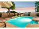 Inviting backyard pool with stone accents, landscaped surroundings and a calming waterfall feature at 4960 E Dale Ln, Cave Creek, AZ 85331