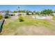 Expansive backyard with manicured lawns, mature trees, and a community pool, offering a serene outdoor retreat at 5209 N 78Th St, Scottsdale, AZ 85250