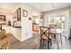 Bright dining area with glass table and chairs, with an opening to the Kitchen and access to the patio at 5209 N 78Th St, Scottsdale, AZ 85250