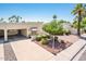 Expansive front yard with desert landscaping, complemented by a covered patio and desert landscaping at 5209 N 78Th St, Scottsdale, AZ 85250