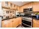 The kitchen offers stainless steel appliances, light cabinets, and open view to the dining area at 5209 N 78Th St, Scottsdale, AZ 85250