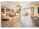 Bright living room featuring wood floors, neutral decor, a ceiling fan and a view into the kitchen at 5209 N 78Th St, Scottsdale, AZ 85250