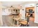 Open-concept living area featuring a dining table, living room, and a kitchen with wood cabinets at 5209 N 78Th St, Scottsdale, AZ 85250
