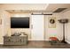 Cozy living room featuring a sliding barn door, a TV, and a console table with decor at 5209 N 78Th St, Scottsdale, AZ 85250