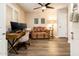 Bright home office with desk, monitors, comfy settee, and ceiling fan at 5209 N 78Th St, Scottsdale, AZ 85250