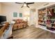Comfortable home office with storage shelves, settee, and modern desk setup at 5209 N 78Th St, Scottsdale, AZ 85250