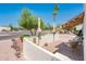 Charming patio area with a patterned awning and inviting seating, surrounded by lush desert landscaping at 5209 N 78Th St, Scottsdale, AZ 85250