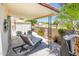 Charming covered patio with outdoor seating, grill, view of the pool and manicured landscaping at 5209 N 78Th St, Scottsdale, AZ 85250
