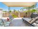 Outdoor patio with stylish seating area under a shaded cover and decorative statue at 5209 N 78Th St, Scottsdale, AZ 85250