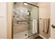 Modern shower with patterned tile, glass door, and built in niche for toiletries at 5209 N 78Th St, Scottsdale, AZ 85250