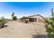 Single-story home exterior with gravel landscaping, a carport, and mature greenery at 5902 W Orange Dr, Glendale, AZ 85301